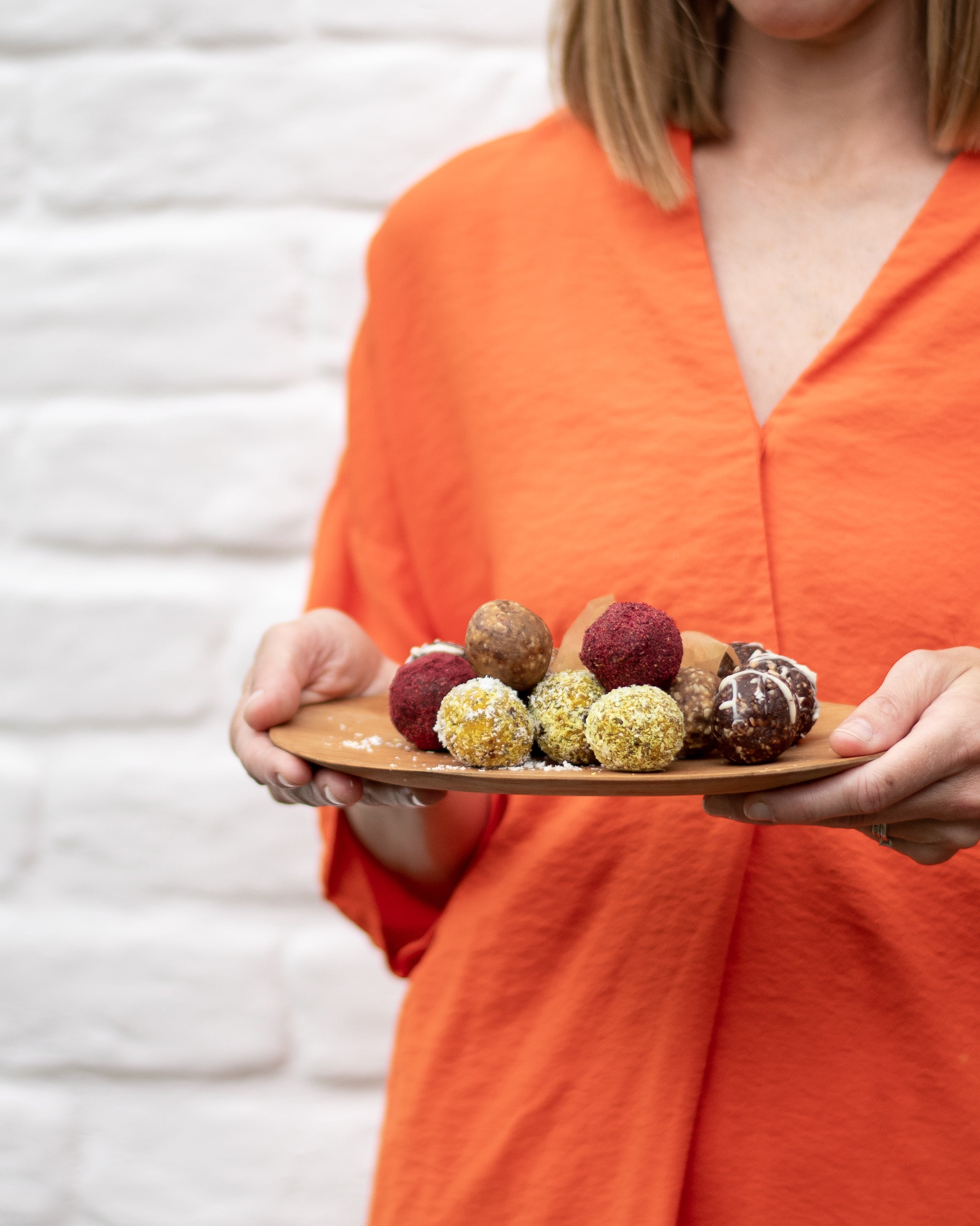 Claire with a plate full of a selection of energy ball flavours